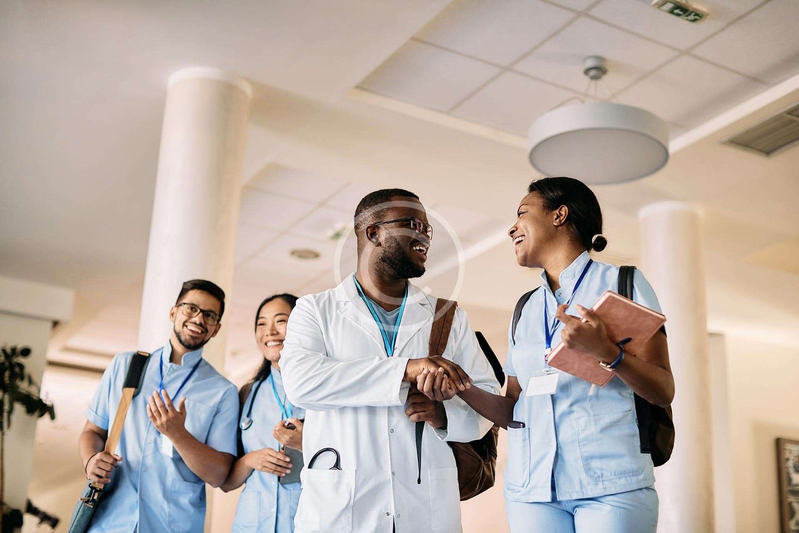 Doctors and nurses smiling an shaking hands