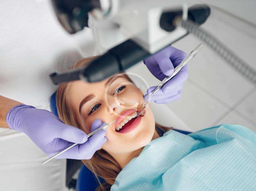 Dentist performing dental care on a female patient