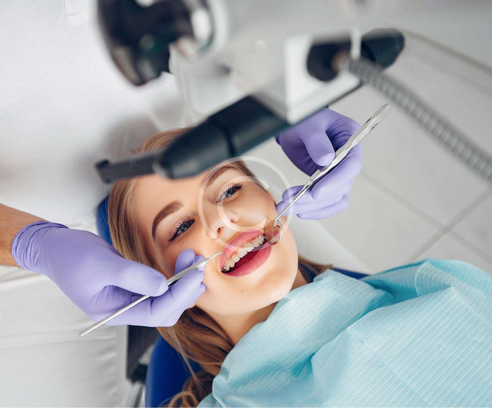 Dentist performing dental care on a female patient