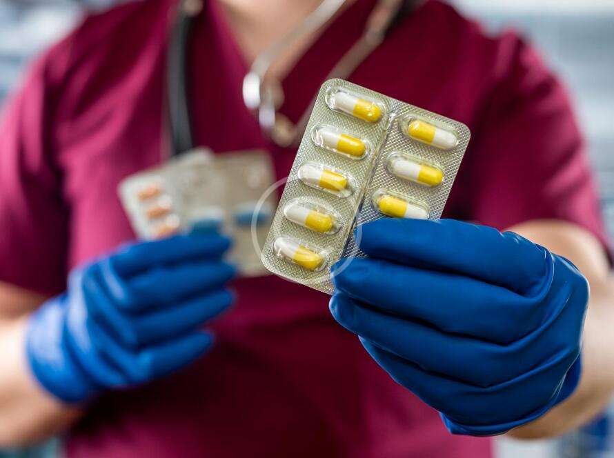 Dentist offering medication to a patient