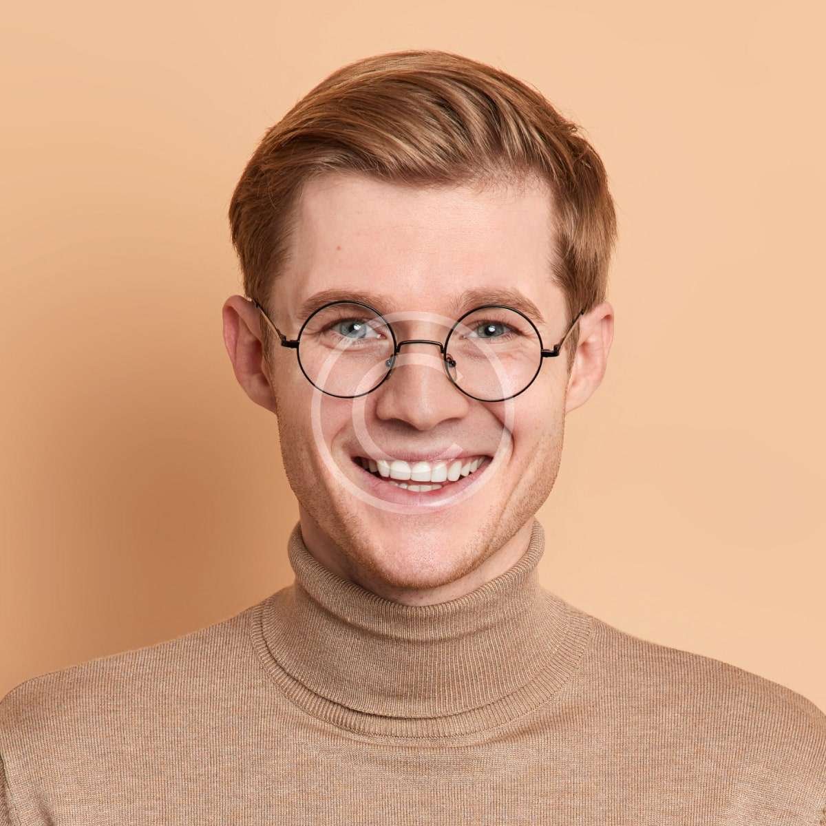 Smiling red-haired male with brown shirt