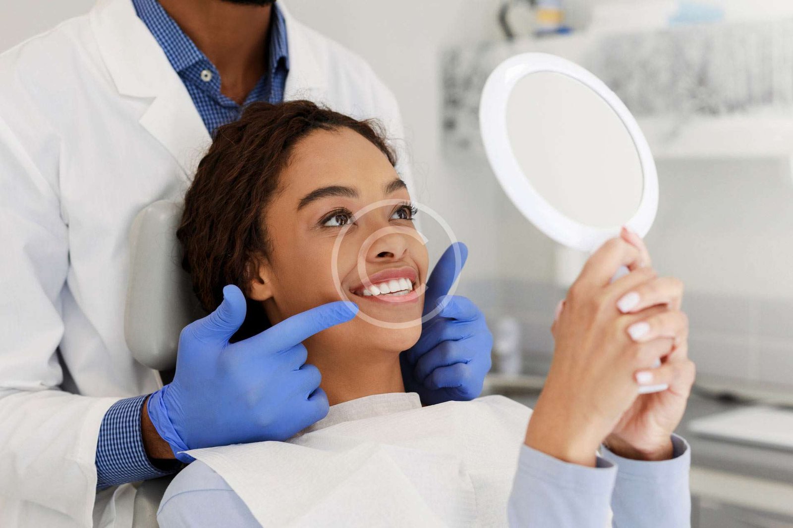 Female smiling using a mirror