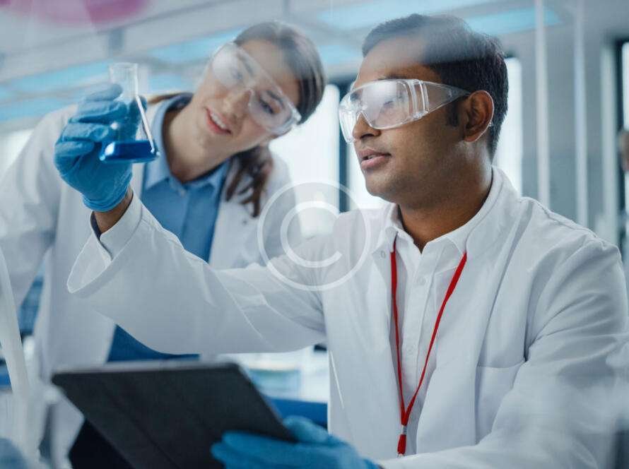 Two medical pharmacists analyzing chemicals in bottle