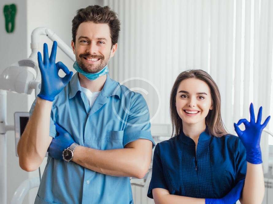Male and female doctors making an OK hand gesture