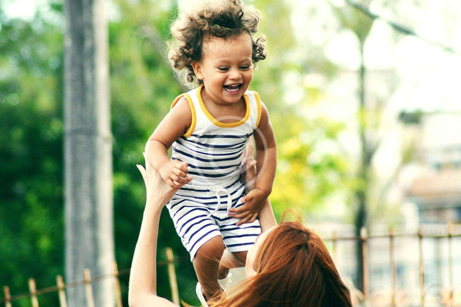 Adult woman lifting a child in her arms