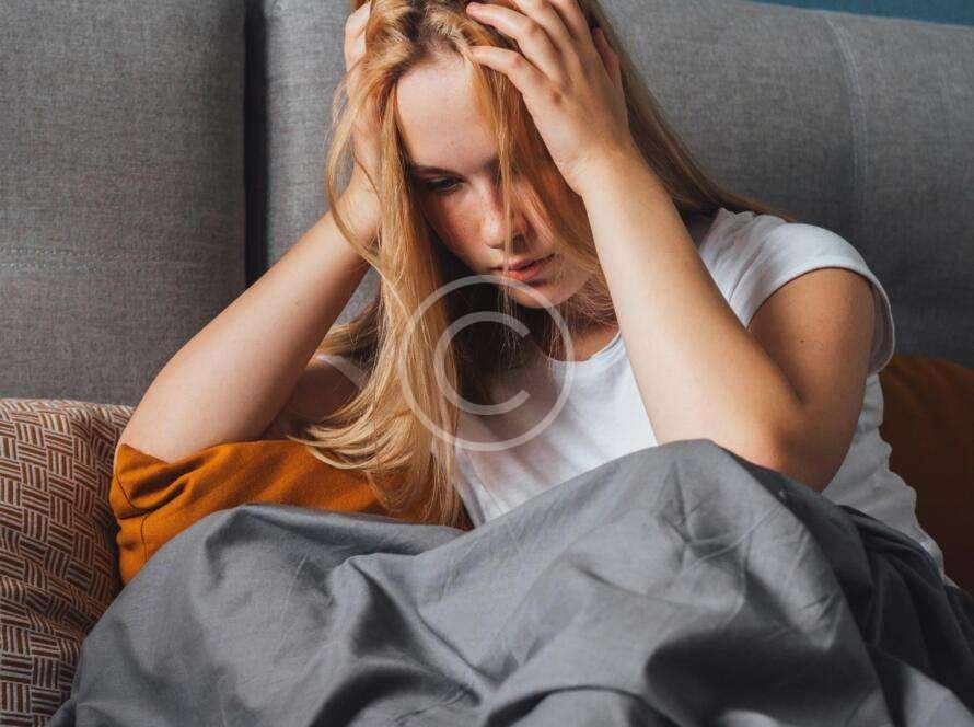 Woman covering her head with her hands