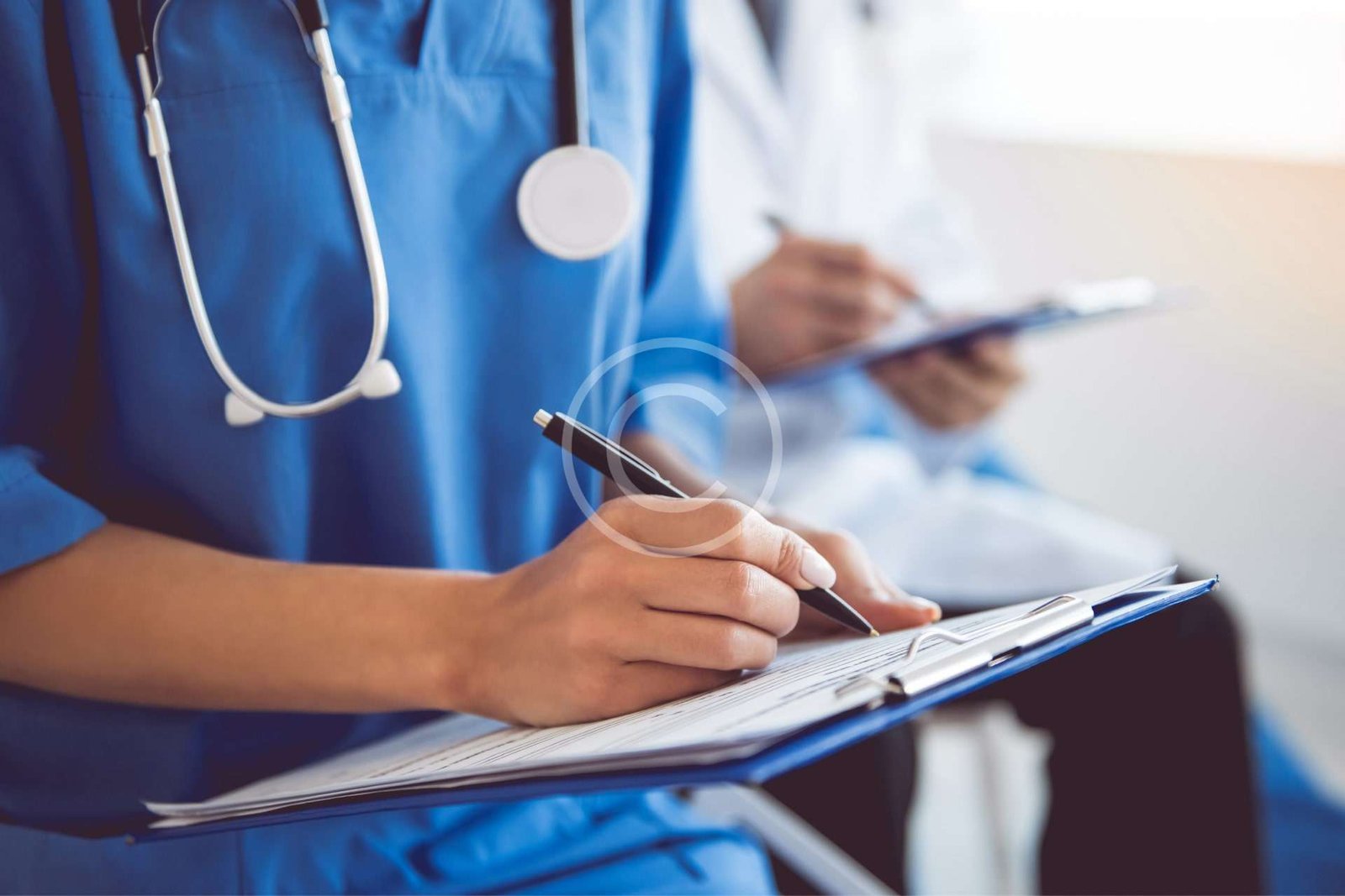 Nurse writing on clipboard