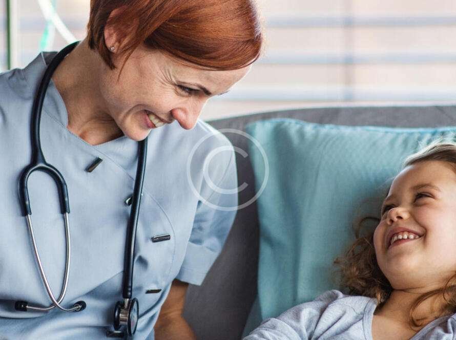 Female doctor with a young girl patient