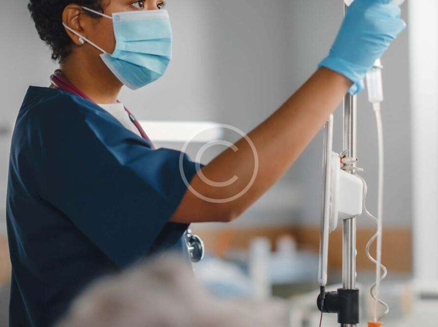 Female nurse checking liquid in a medical bag