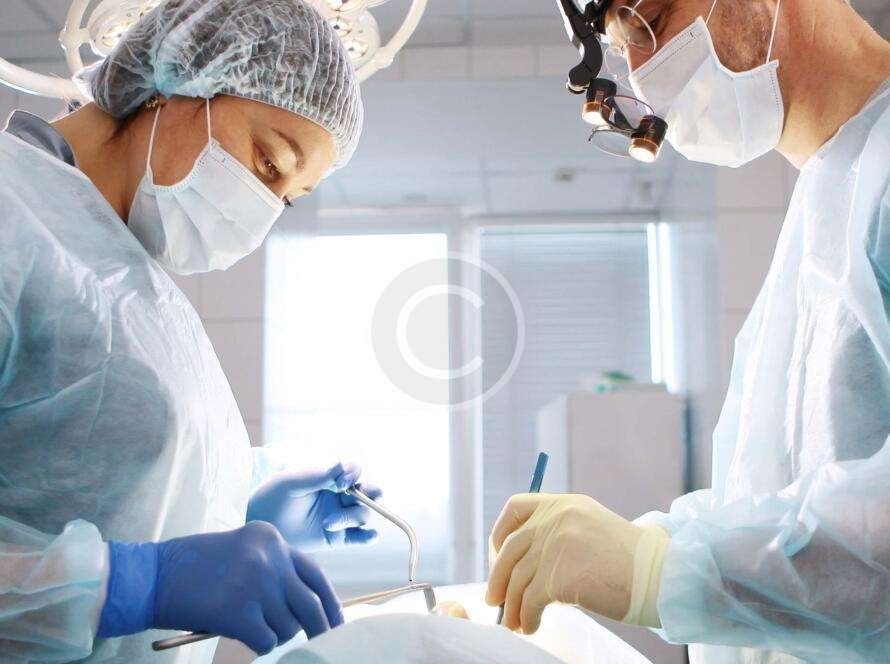 Doctors performing surgery on a patient
