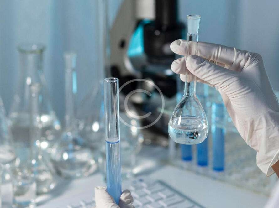 Medical scientist holding two flasks with liquid