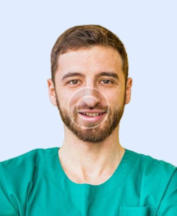 Smiling male doctor with green shirt