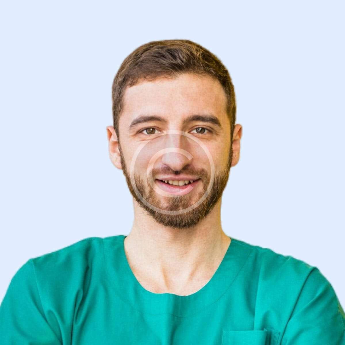 Smiling male doctor with green shirt