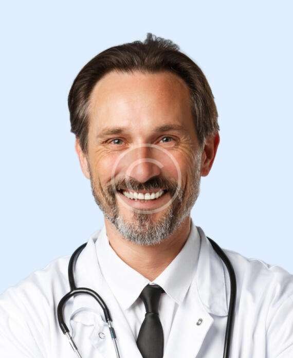 Smiling male doctor with white shirt and white lab-coat