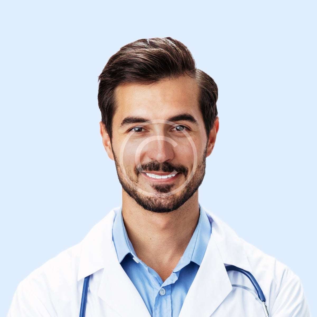 Smiling male doctor with blue shirt and white lab-coat