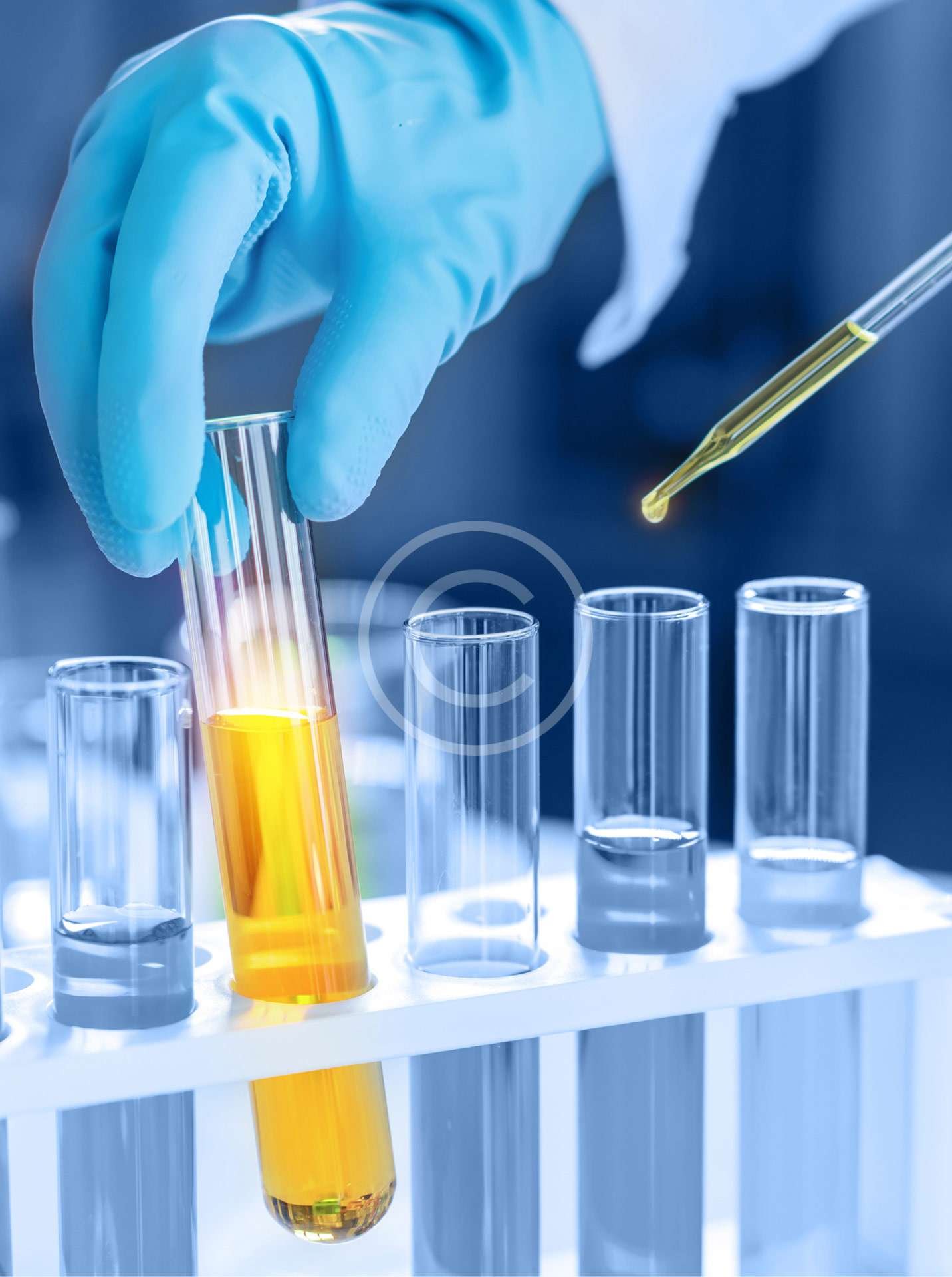 Scientist holding a flask with yellow liquid