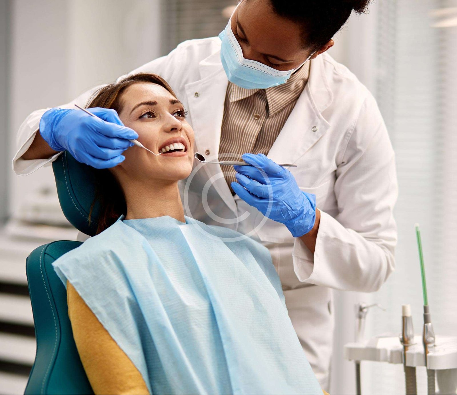 Female patient receiving dental treatment from a dentist