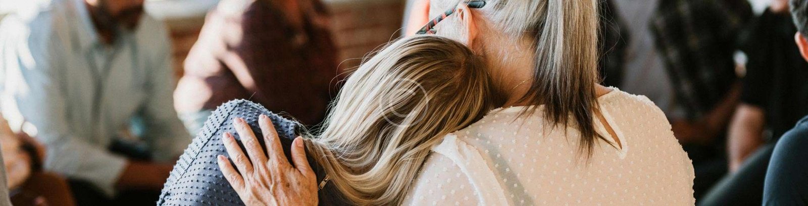 Woman resting her head on another woman's shoulder