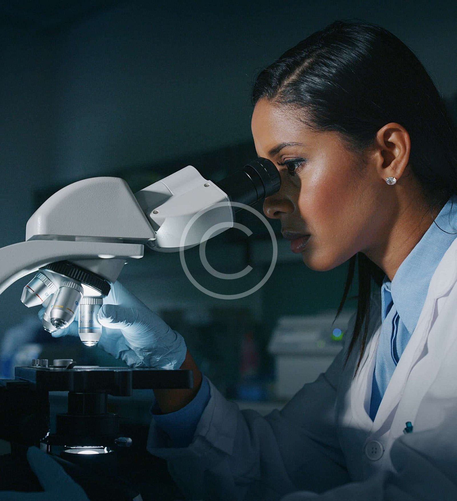 Scientist looking through microscope